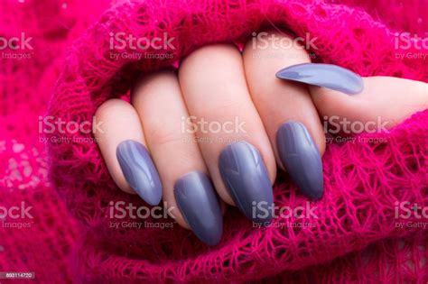Woman Showing Off Her New Stiletto Nails And Pink Knitted Sweater Stock
