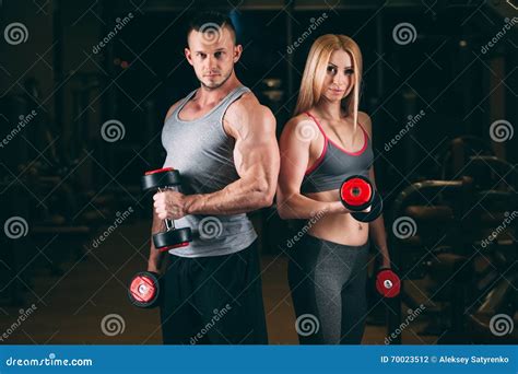 Beautiful Young Sporty Couple Showing Muscle And Workout In Gym