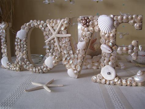 While your choice will be influenced greatly by whether or not you have a theme such as beach party, tropical, or mermaid fantasia, there are a few ideas that can be used without any specific theme for any kind. nautical beach weddings seashell wedding sign | OneWed.com