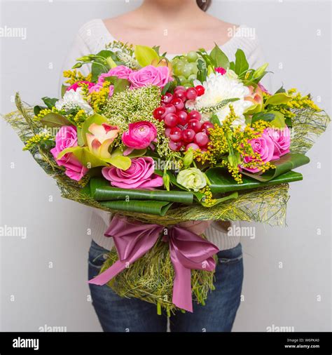 Very Nice Florist Woman Holding A Beautiful Colourful Blossoming Flower