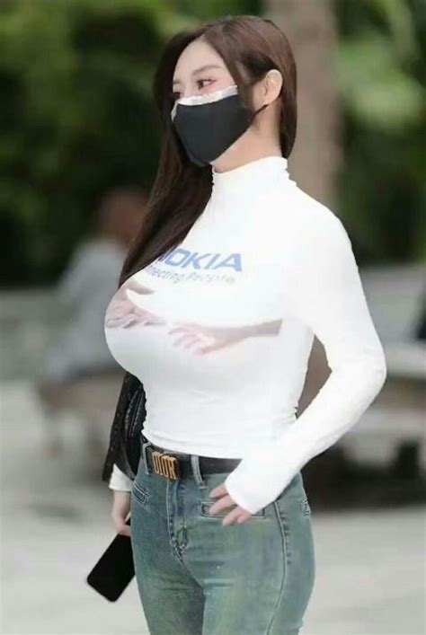 A Woman Wearing A Face Mask And Jeans