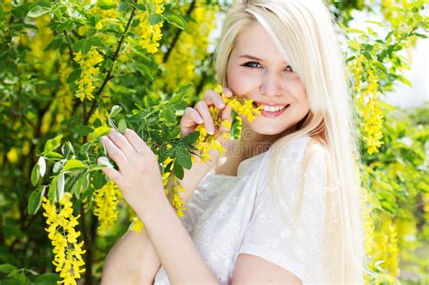 Beautiful Blonde Girl With Yellow Flowers Stock Photo Image Of Nature