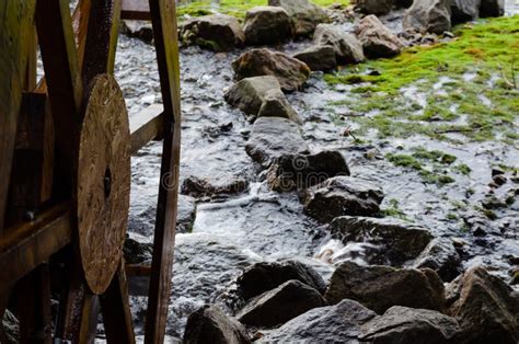 Wooden Grist Mill Water Wheel Turning With The Flow Of Water Closeup