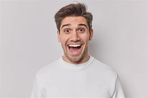 Premium Photo Portrait Of Happy Cheerful Guy Keeps Mouth Opened