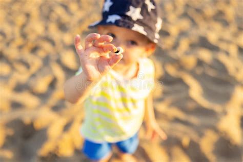 Child Holding Sea Shell On The Beach By The Sea Stock Photo Image Of
