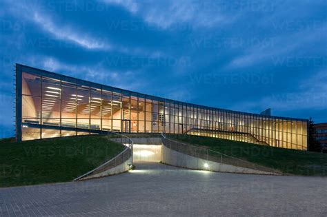 Modern University Buildings Glass Facade Lit Up At Night On A Curved