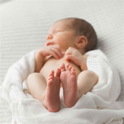 Newborn Baby Laying On Back With Feet In Focus Moments In Light