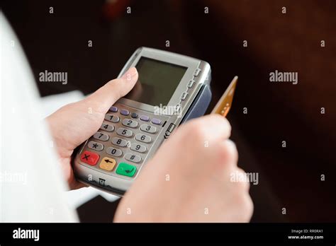 Hand Swiping Debit Card On Pos Terminal Stock Photo Alamy