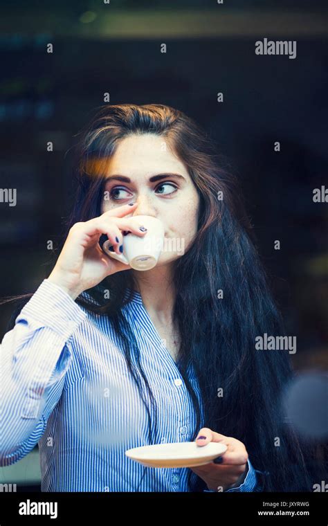 Curious Caucasian Woman Sipping Coffee Outdoors Stock Photo Alamy