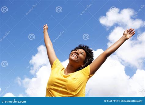Cheerful Young Woman With Hands Raised Towards Sky Stock Photo Image