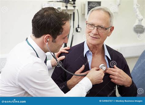 Doctor Examining Senior Male Patient In Hospital Stock Image Image Of