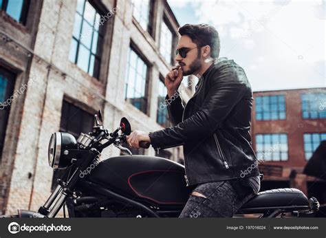 Handsome Bearded Biker Smoking Sigarette While Sitting Classic Style