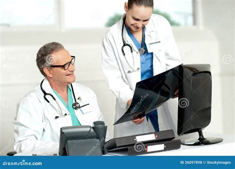 Team Of Two Doctors Reviewing X Ray Report Stock Photo Image Of