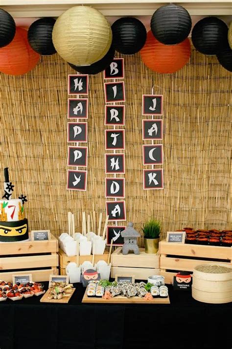 A Table Topped With Lots Of Food Next To Black And White Decorations On