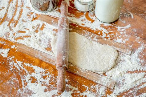 Rolling Pin On A Wooden Decorated Table Covered With Baked Flour