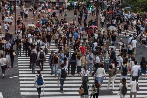 Crowd Of People Walking On Shinjuku Pedestrian Crossing In Tokyo Japan