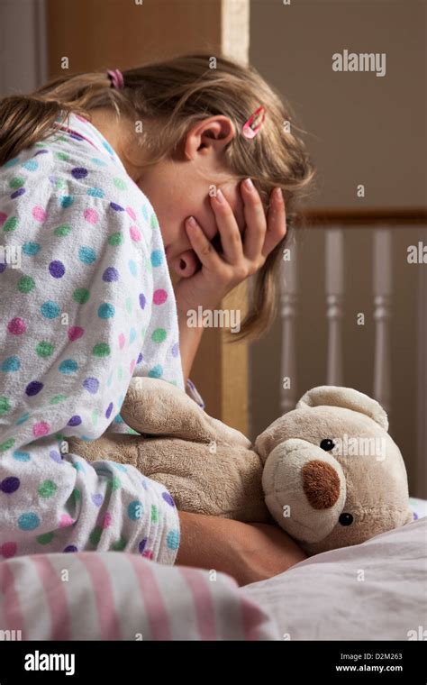 Young Female Wearing A Pajamas Clutching Her Teddy Bear Hand Covering