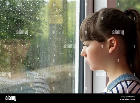 Sad Child Looking Through Window Stock Photo Alamy