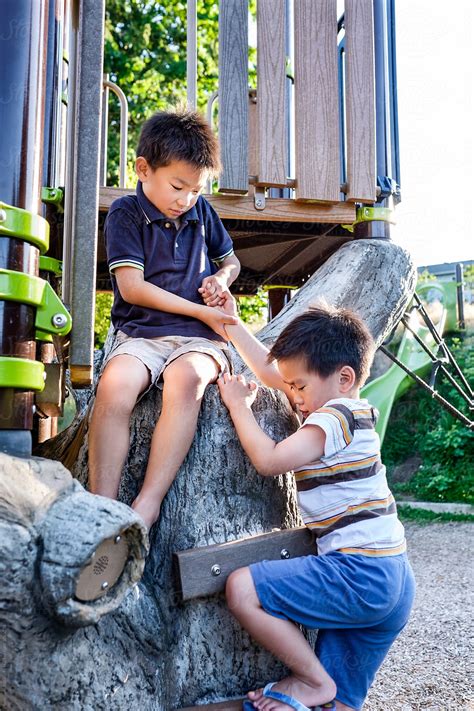 Asian Kids Helping Each Other In The Playground By Take A Pix Media