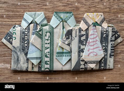 Origami Shirt Made Of Dollar Banknote On Wooden Background Close Up