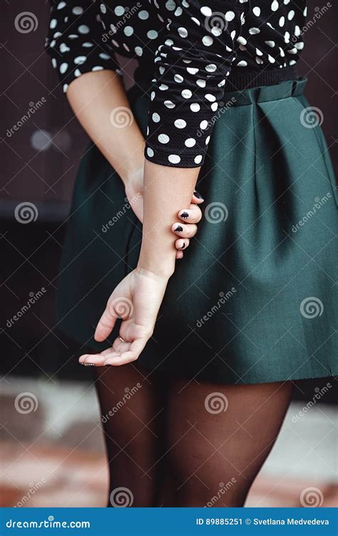 The Girl The Teenager In A Short Skirt Stands With His Hands Stock