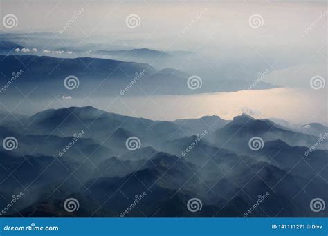 Aerial View Of Misty Mountains Lake And Clouds Above The Mountain