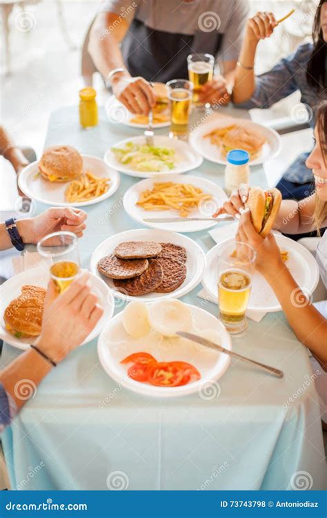 Friends Eating Hamburgers Together Stock Photo Image Of Beer Buns