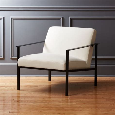 French deco style armchair with nickel nailheads and black lacquered wooden legs. Cue White Chair with Black Legs + Reviews | CB2