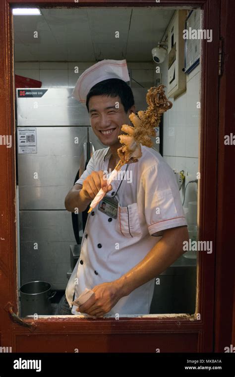 chinese cook working in asian restaurant kitchen in beijing china asia traditional food shop