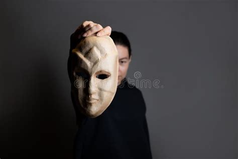 Hiding Behind A Mask A Young Woman In A Dark Hoodie Hides Her Face