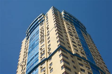 High Yellow Modern Building On Blue Cloudless Sky Vertical View Stock