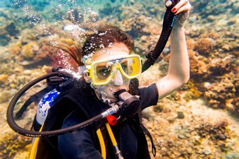 Woman In Vacation Scuba Diving To Tropical Coral Reef Stock Photo