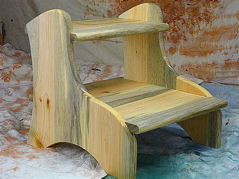 A Wooden Step Stool Sitting On Top Of Snow Covered Ground