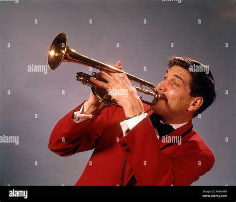 1960s 1970s Man Playing Trumpet In Red Jacket Musician Trumpets