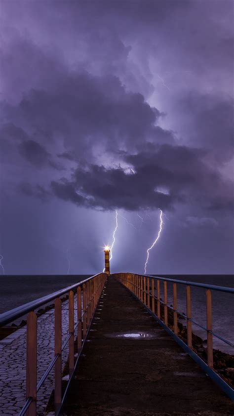 Download Wallpaper 1350x2400 Pier Sea Lighthouse Lightning