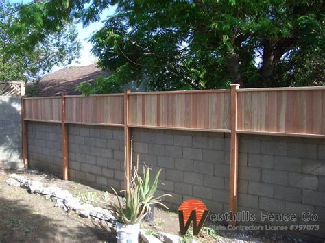 Learn how to build a fence. Tongue and gvoove redwood fence on top of wall (с ...