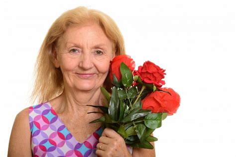 Premium Photo Senior Woman Holding Red Roses