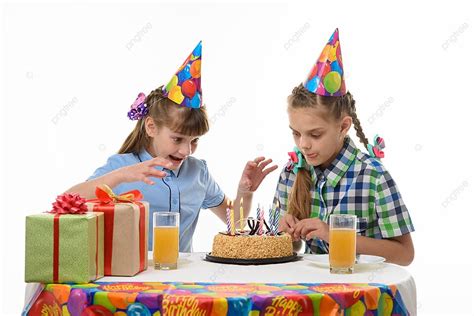 Joyful Girls Eagerly Dive Into A Birthday Cake To Satisfy Their Sweet