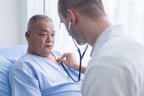 Doctor Using Stethoscope To Listen To Patients Heart 1259892 Stock