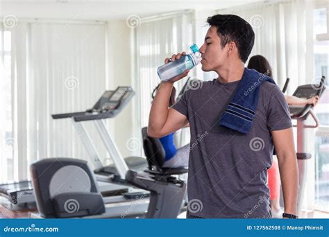 Man Are Drinking Water In The Gymafter The Exercise Stock Photo