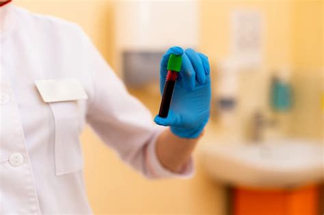Premium Photo Lab Technician Holding Blood Tube Sample For Study