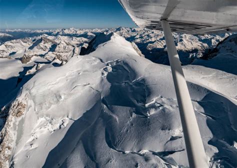 380 Plane Flying Over Snowy Mountains Stock Photos Pictures And Royalty