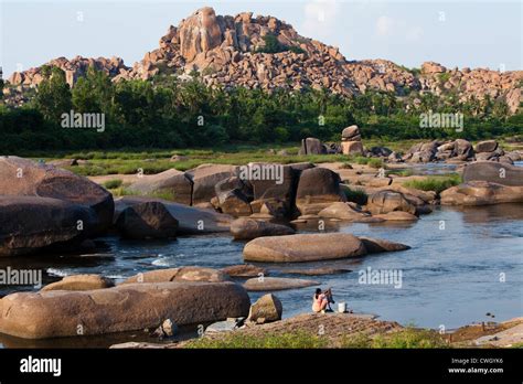 Indian Woman Washing Clothes In The Tungabhadra River In Hampi Stock