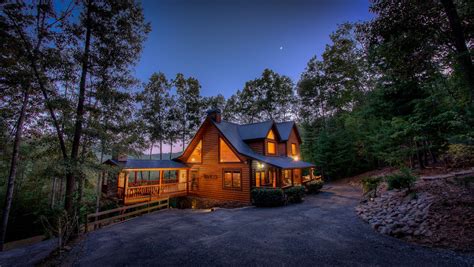 A Cozy Cabin In Blue Ridge Georgia Glows Warmly Among Trees And