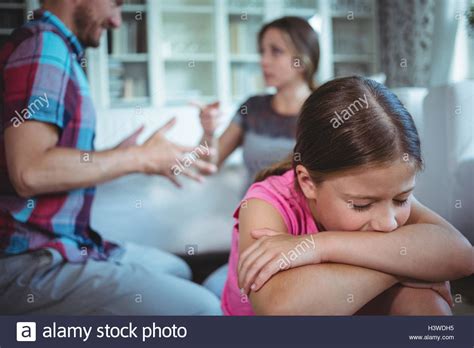 Sad Girl Listening To Her Parents Arguing Stock Photo Alamy