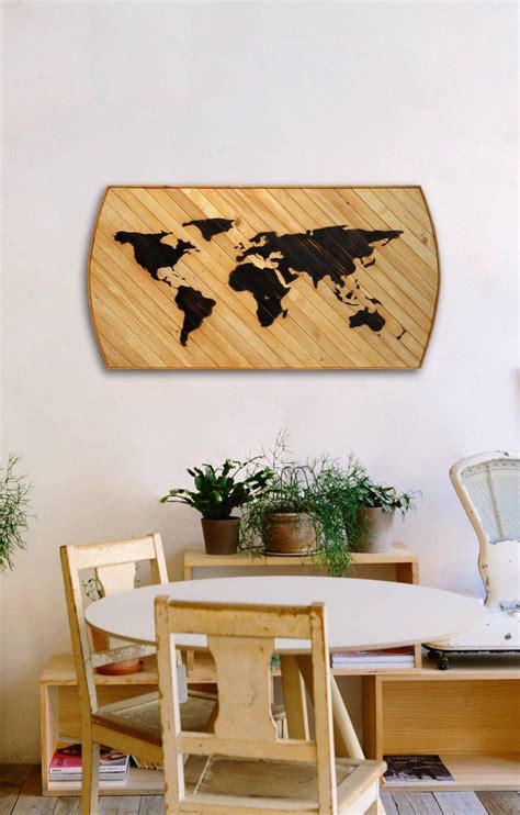 A Wooden World Map Hanging On The Wall Above A Dining Room Table With