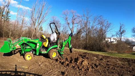 John Deere 1025r First Day Operating 260 Backhoe Digging Holes