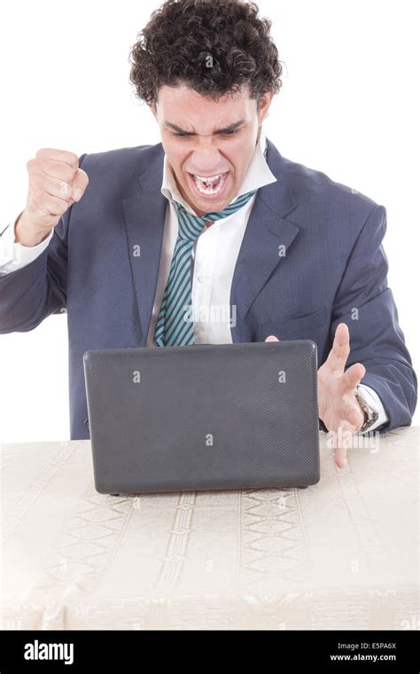 Photo Of An Angry Caucasian Business Male Frustrated With Work Sitting In Front Of Laptop With