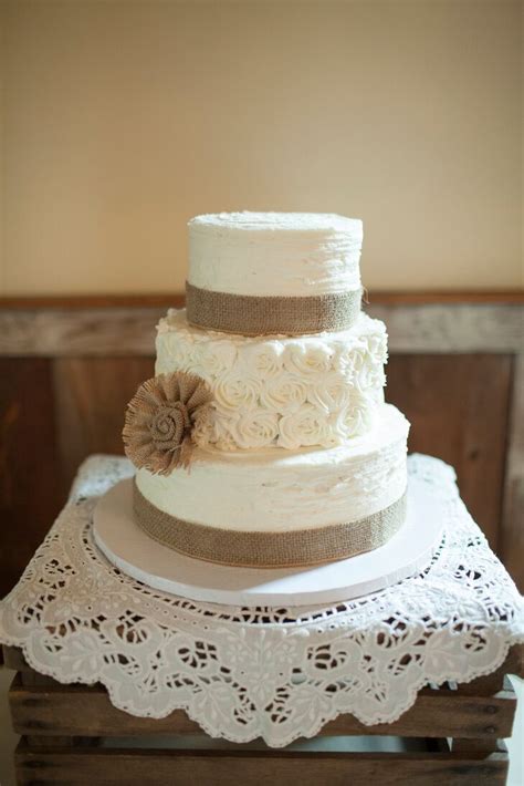 White Wedding Cake With Rosette Details And Burlap Ribbon