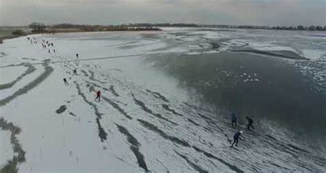 Ice Skaters Glide Across Frozen Dutch Lake Video